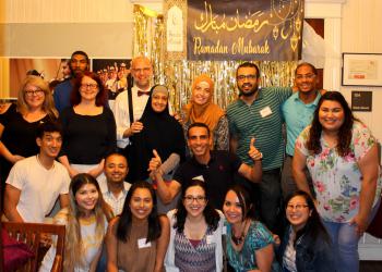 Group photo in front of Ramadan Kareem Banner