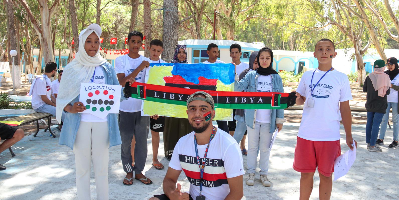 A group of young Libyans at a summer camp, holding the Libyan flag