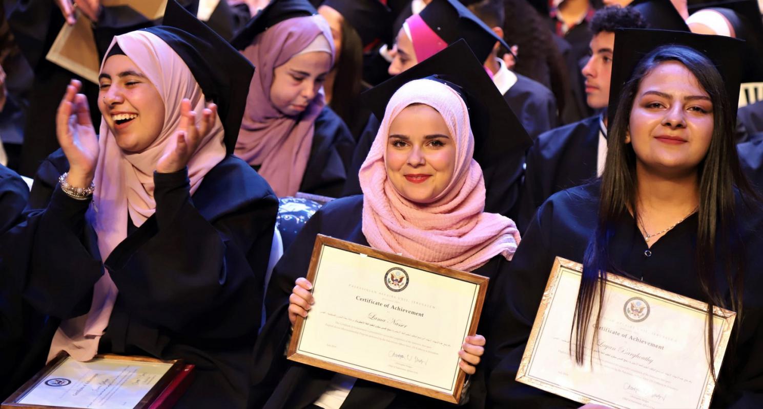 Three Access graduates holding certificates during graduation