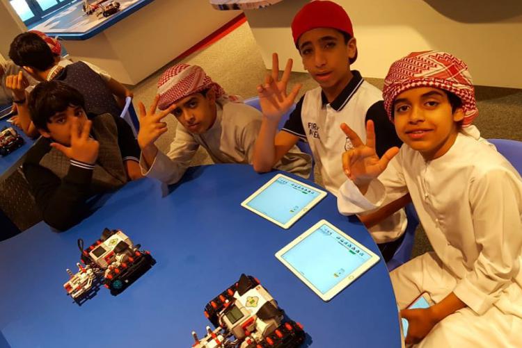 Kids posing while sitting at a table