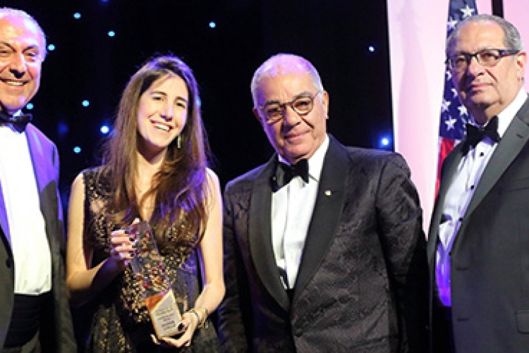 Flanked (left to right) by ALAB Chair Anis Nassar, Gala Chair Harry Nadjarian, and AMIDEAST President and CEO Theodore Kattouf, Nour Semaan holds the Education Hero Award that she accepted on behalf of her late father, Maroun Semaan.