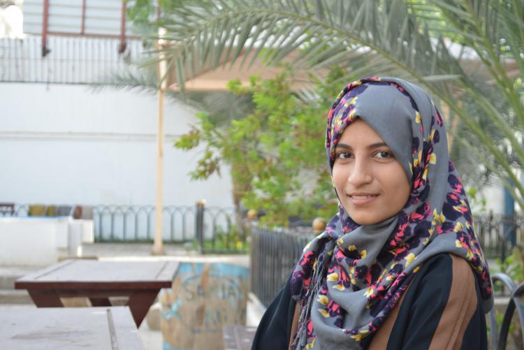 Yemeni female college student sitting outside