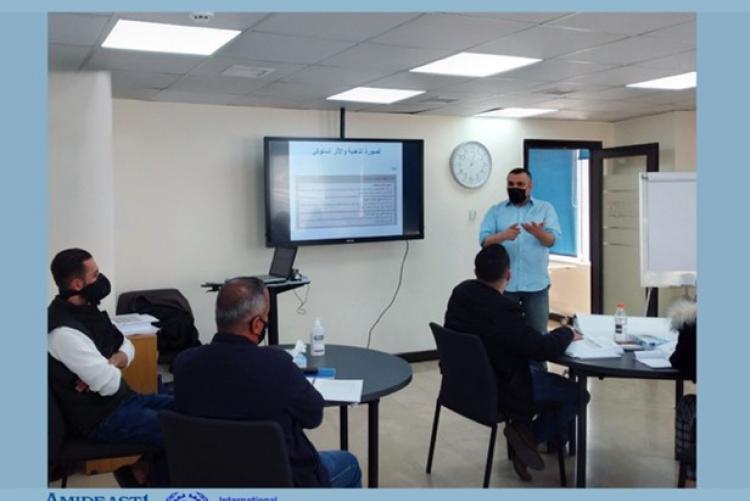 Male teachers in class room in a training