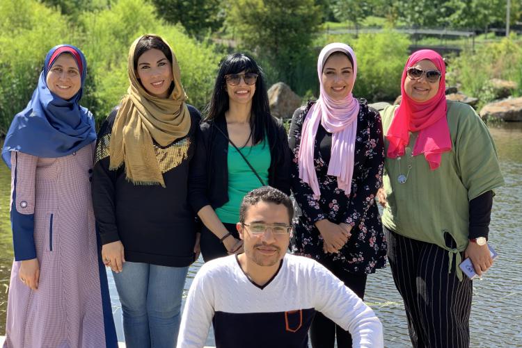A group of Fulbrighters pose for a picture outside.
