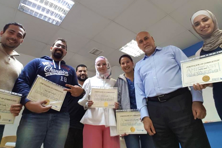 Students hold up certificates