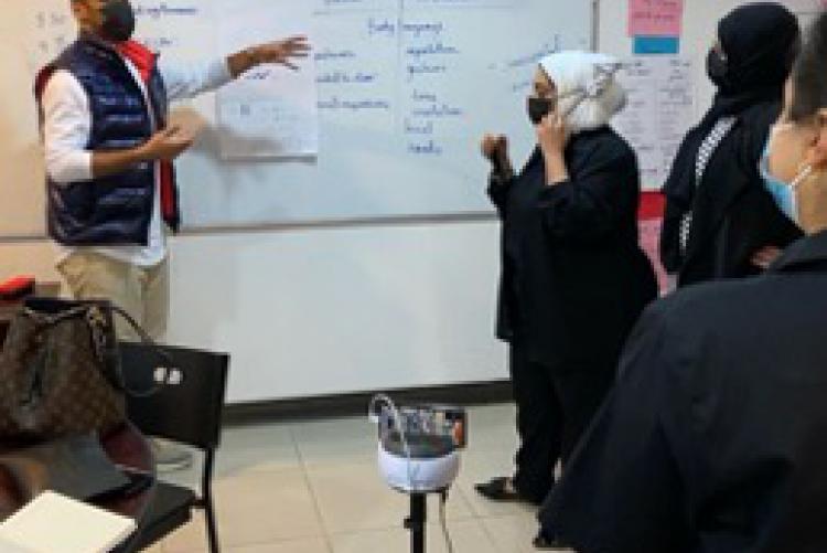 Kuwaiti English teachers in a PCELT session assisted by a SWIVL robot