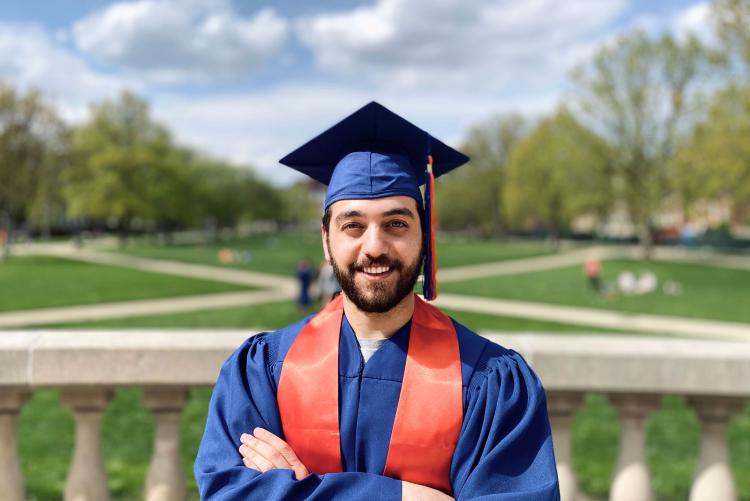 Male student in blue cap and gown