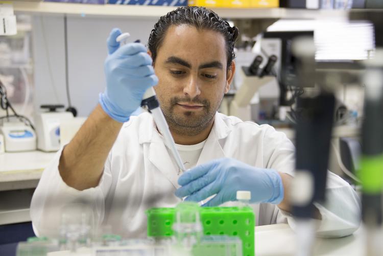 Male in lab uses syringe