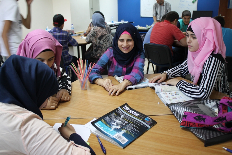 Girls working in a group on a English language classroom assignment