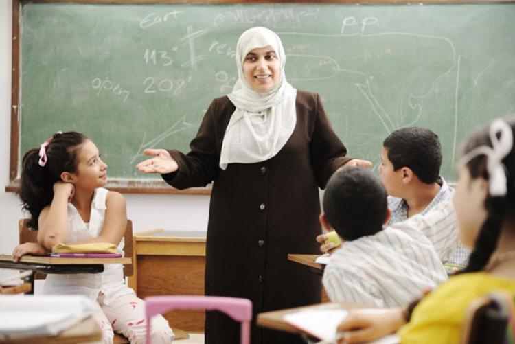 Female teacher in class with young kids