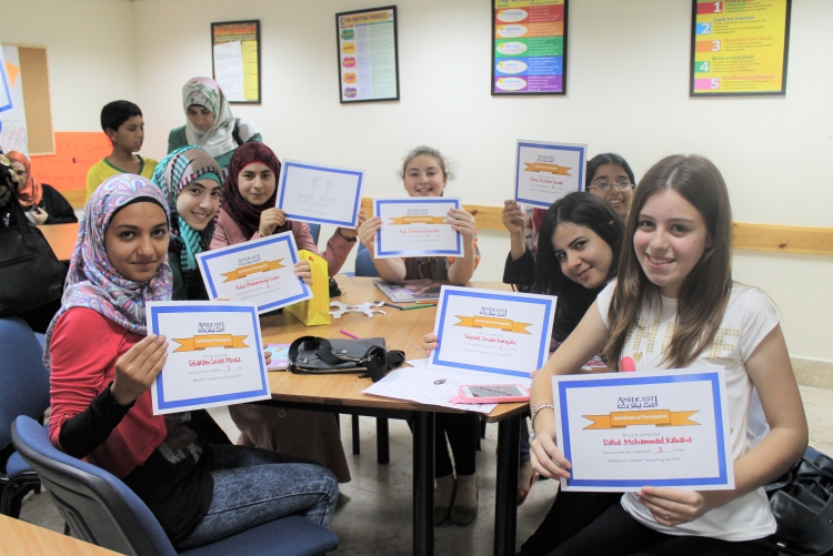 Students holding course completion certificates