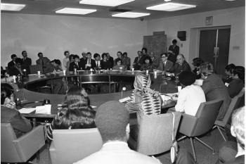 Group of people sitting at a round table 