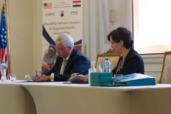 Representatives of the Egyptian government and Amideast sign the MOU.