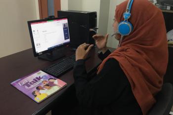 A female teacher gives lecture through Zoom App