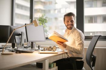 Photo of person sitting on a chair in front of computer