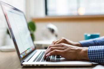 Photo of person typing on a keyboard