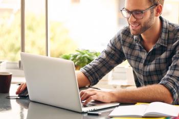 Man typing on a laptop