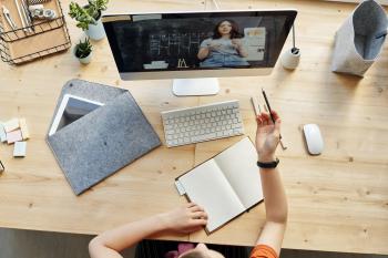 Aerial shot of a student participating in a video call on their computer