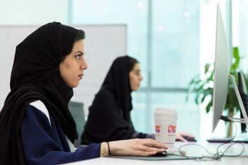 Picture of two Saudi women working on computers
