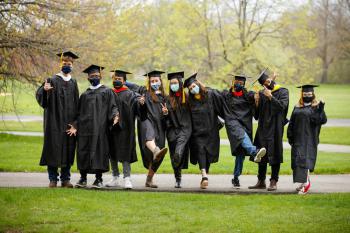 A group of graduating college students in their gowns.