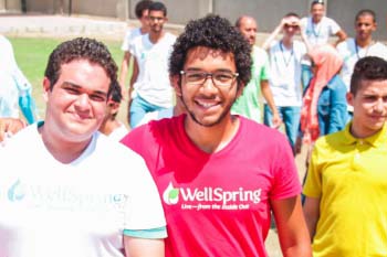 Male students in the HEI program smile at the camera