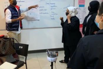 Kuwaiti English teachers in a PCELT session assisted by a SWIVL robot