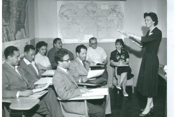 Woman standing in front of a class