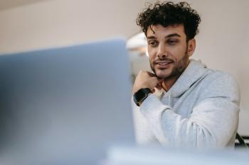 Young man at computer taking a test.