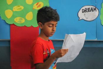 Student reading from a paper