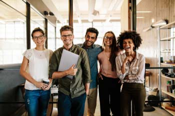 Group of young professionals smile in an office