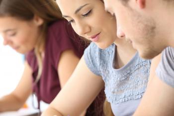 Students writing in a classroom