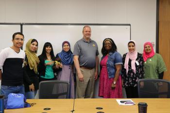 A group of scholars pose with their mentors.