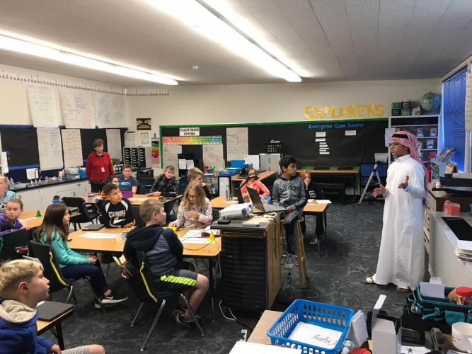 Picture of Saudi exchange student teaching American grade school youth about Saudi Arabia