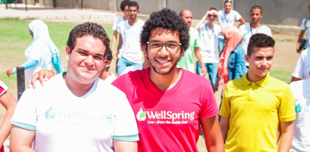 Male students in the HEI program smile at the camera