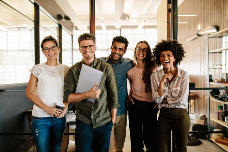 Group of young professionals smile in an office