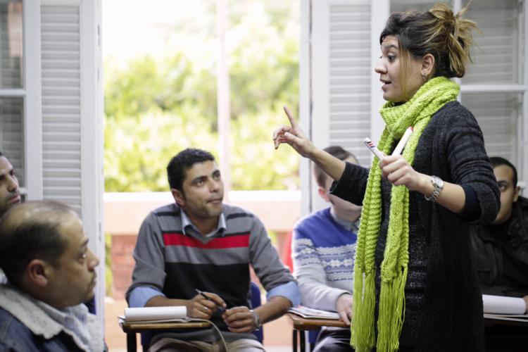 English Teacher talking to students at AMIDEAST field office