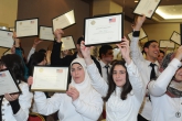 Group of Access students holding certificates in the air