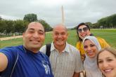 A group of five posting in front of the Washington Monument.