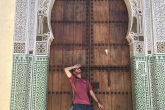 A student posing in front of an ornate door in Morocco