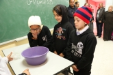 Three students watching a science experiment 