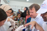 Teachers work with campers as they do a science experiment 