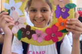 Camper holds up craft project 