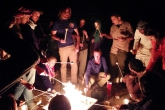 Students roast marshmallows over a fire in Wadi Rum, Jordan