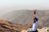 A student doing a yoga pose on Mount Toubkal in Morocco