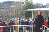 The LTD principal poses in front of a crowd of young female LTD students