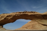 Students sit on a rock bridge in Wadi Rum, Jordan