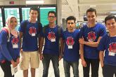 A group of students smile in an airport