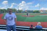 A scholar enjoying a baseball game.