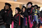 Group of students lined up in cap and gown