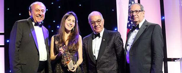 Flanked (left to right) by ALAB Chair Anis Nassar, Gala Chair Harry Nadjarian, and AMIDEAST President and CEO Theodore Kattouf, Nour Semaan holds the Education Hero Award that she accepted on behalf of her late father, Maroun Semaan.